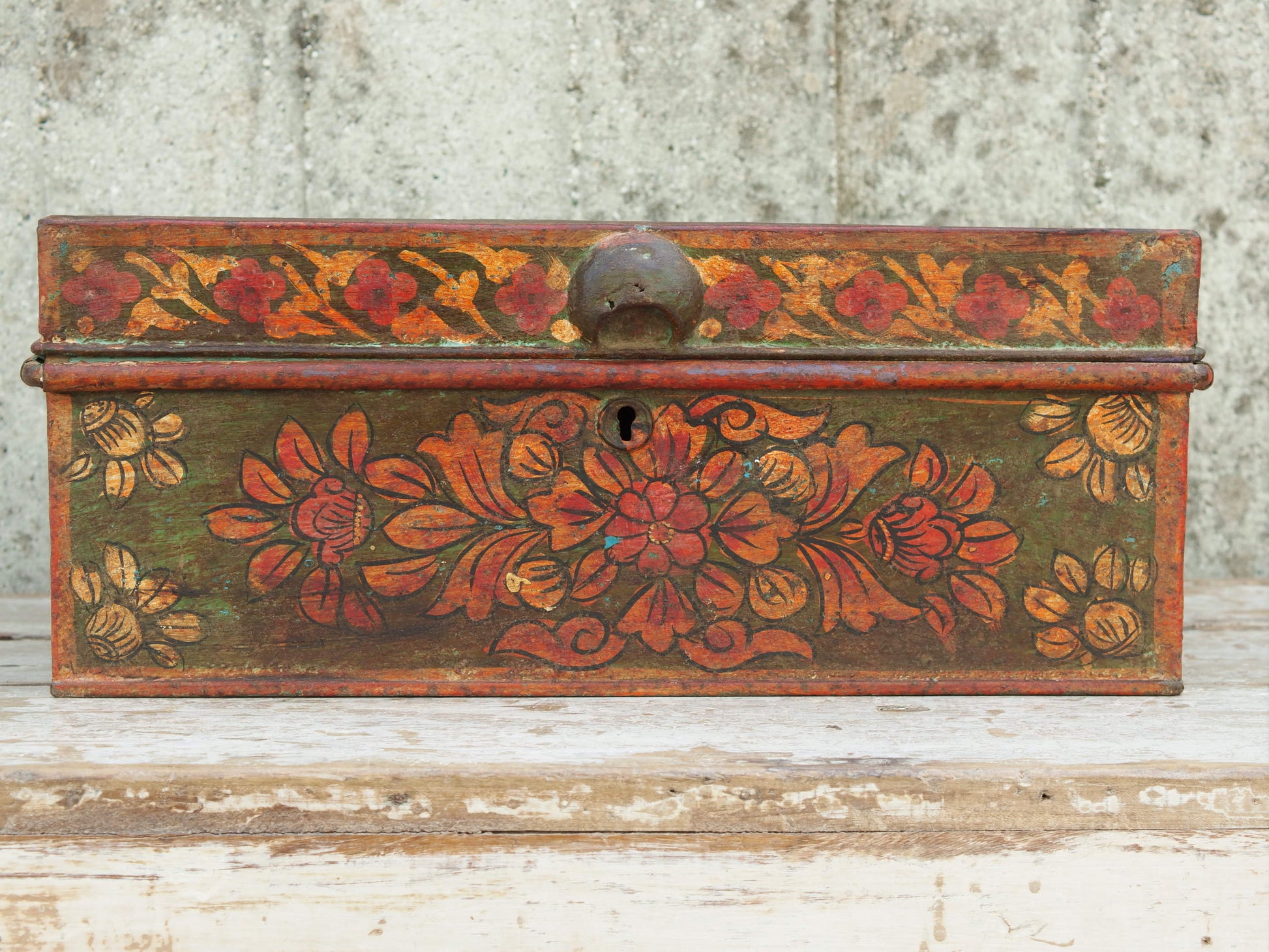 vecchio box, bauletto, scatola, indiana in metallo dipinto con motivi floreali. impiegata solitamente per le offerte nei templi o come cassa nei negozi, motivo per cui sopra vi è un foro dove mettere le offerte. internamente sono presenti vari scomparti. assemblata artigianalmente, originale in ogni parte. pezzo vintage, anno '50/60 pezzo unico.  dimensioni 42x29 h17 cm