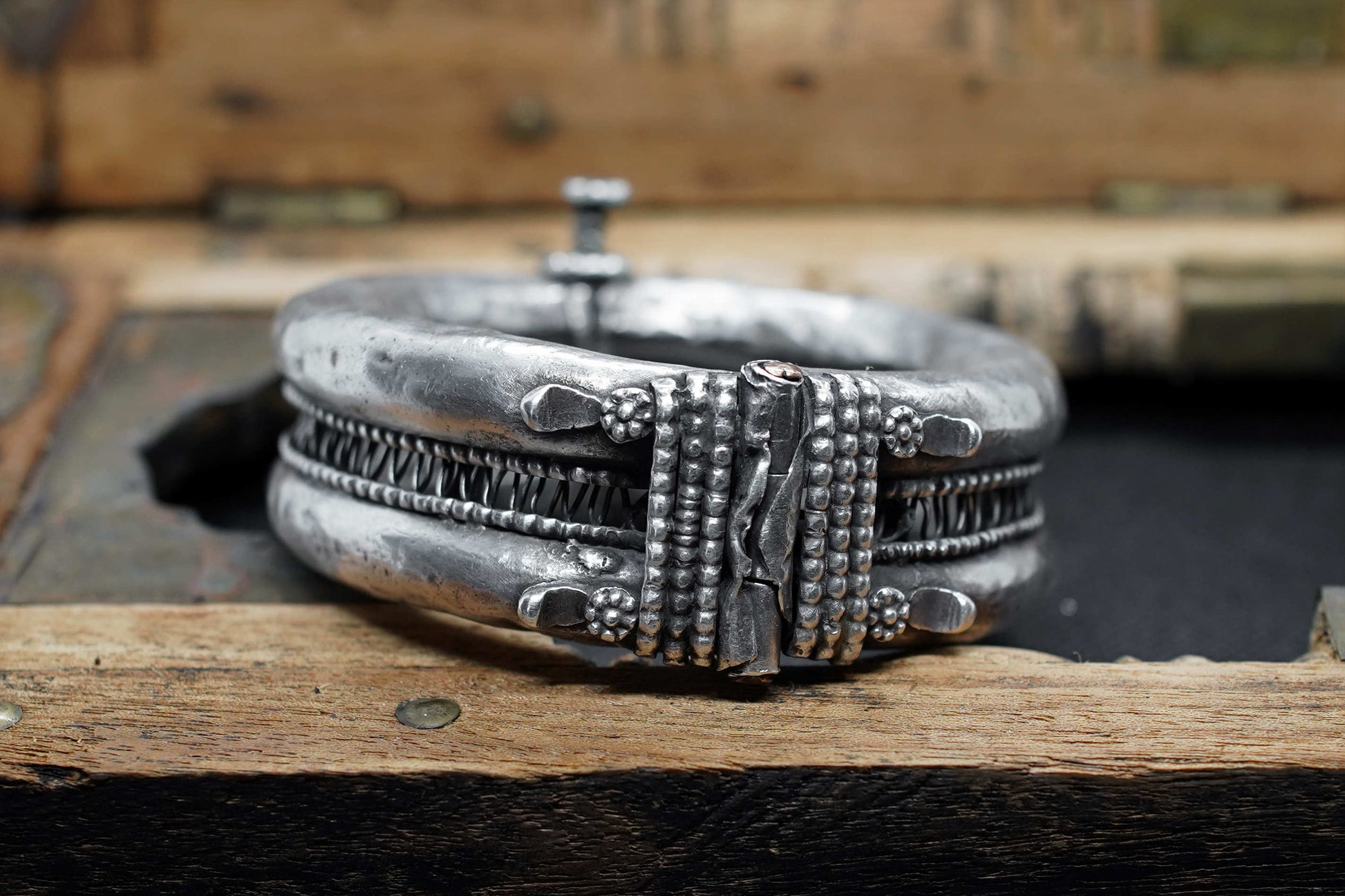 Primo piano delle profonde incisioni geometriche e dello stile arabo nomade sul bracciale antico
