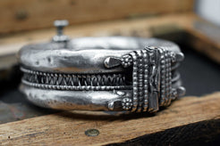 Inquadratura ravvicinata della patina d'epoca e della lavorazione interamente a mano del bracciale