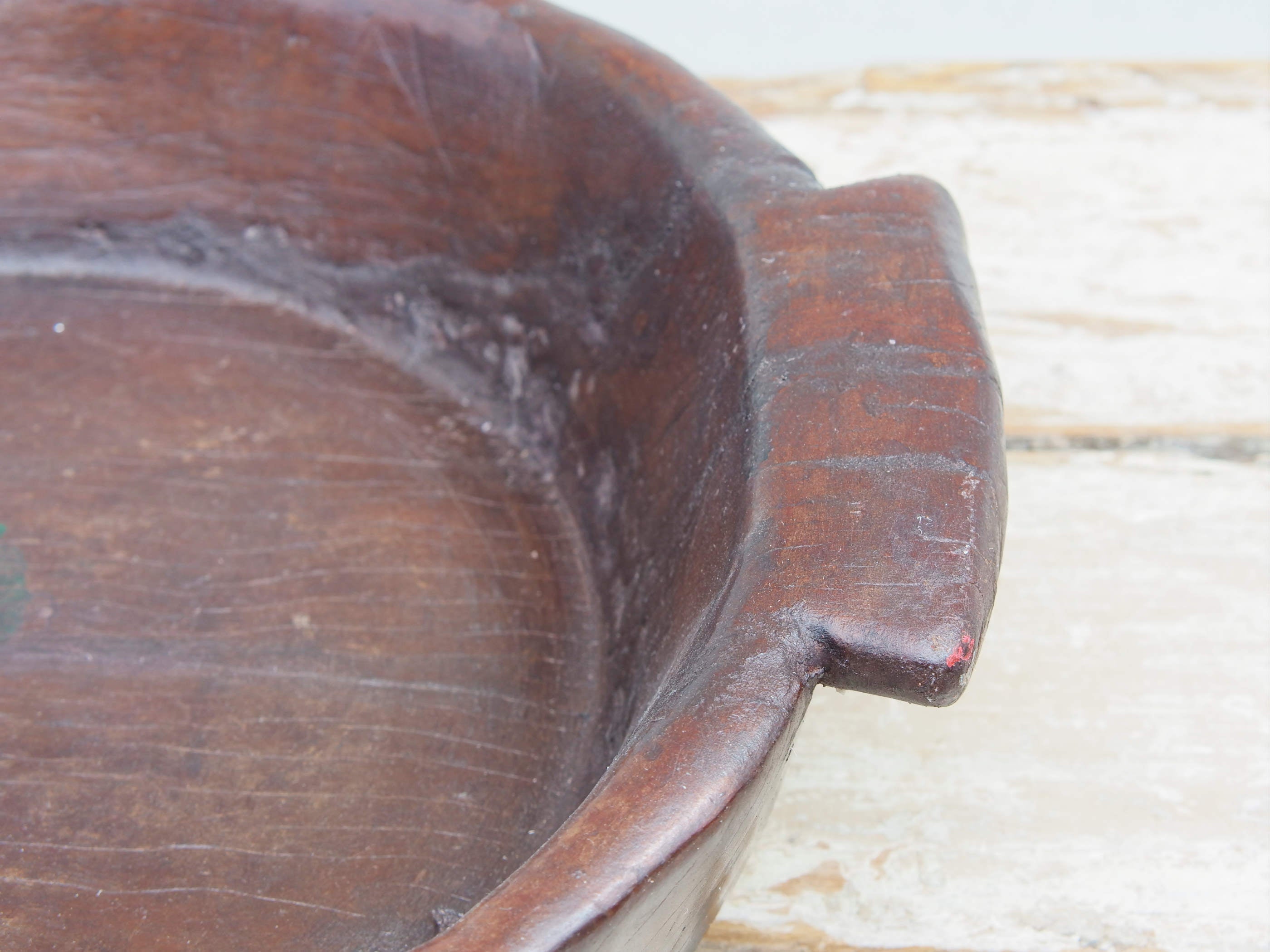 piatto in legno con manico ricavato da un unico tronco di legno con manici. usato in principio come piatto , setaccio per esiccare i cereali tronco unico di teak massello databile inizio / metà 900  dimensioni 47x42 h11cm.
