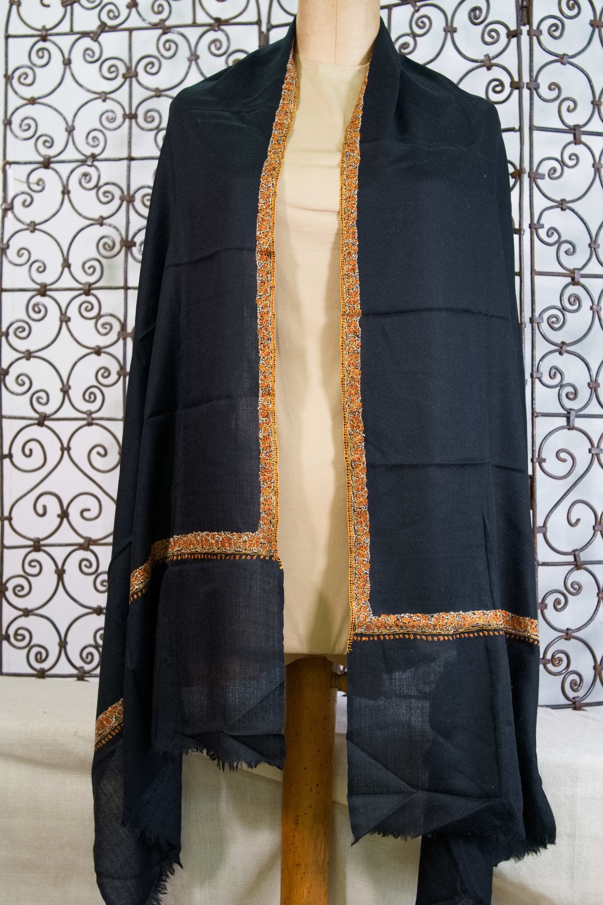 Inquadratura generale dello scialle nero in pashmina con ricami floreali chiari Neemdaur.