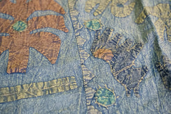 Dettaglio ravvicinato dei ricami artigianali colorati sulla superficie in cotone.