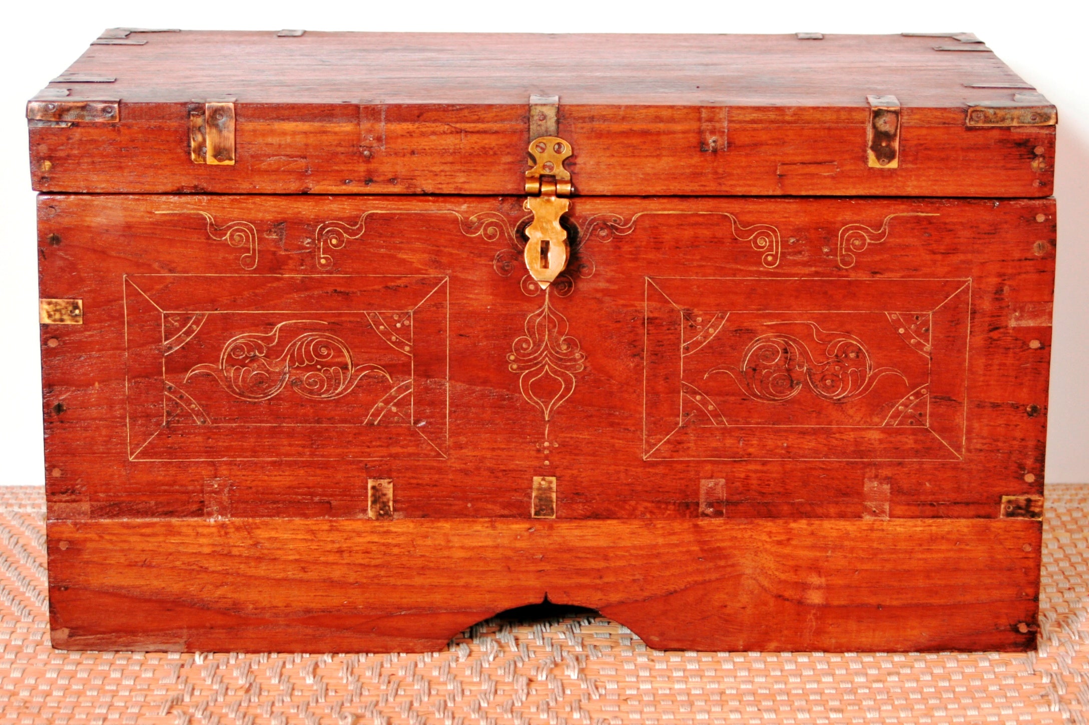 Baule coloniale indiano in teak cesellato con bronzo, utilizzato in origine per trasportare tessuti e gioielli negli spostamenti, internamente ci sono vari scomparti e vani nascosti. Databile fine '800 primi '900. integro ed originale in ogni sua parte, inciosni e cesellature in bronzo sono autentiche. Pezzo unico e di difficile reperibilità. Dimensioni 60x34xh38cm.