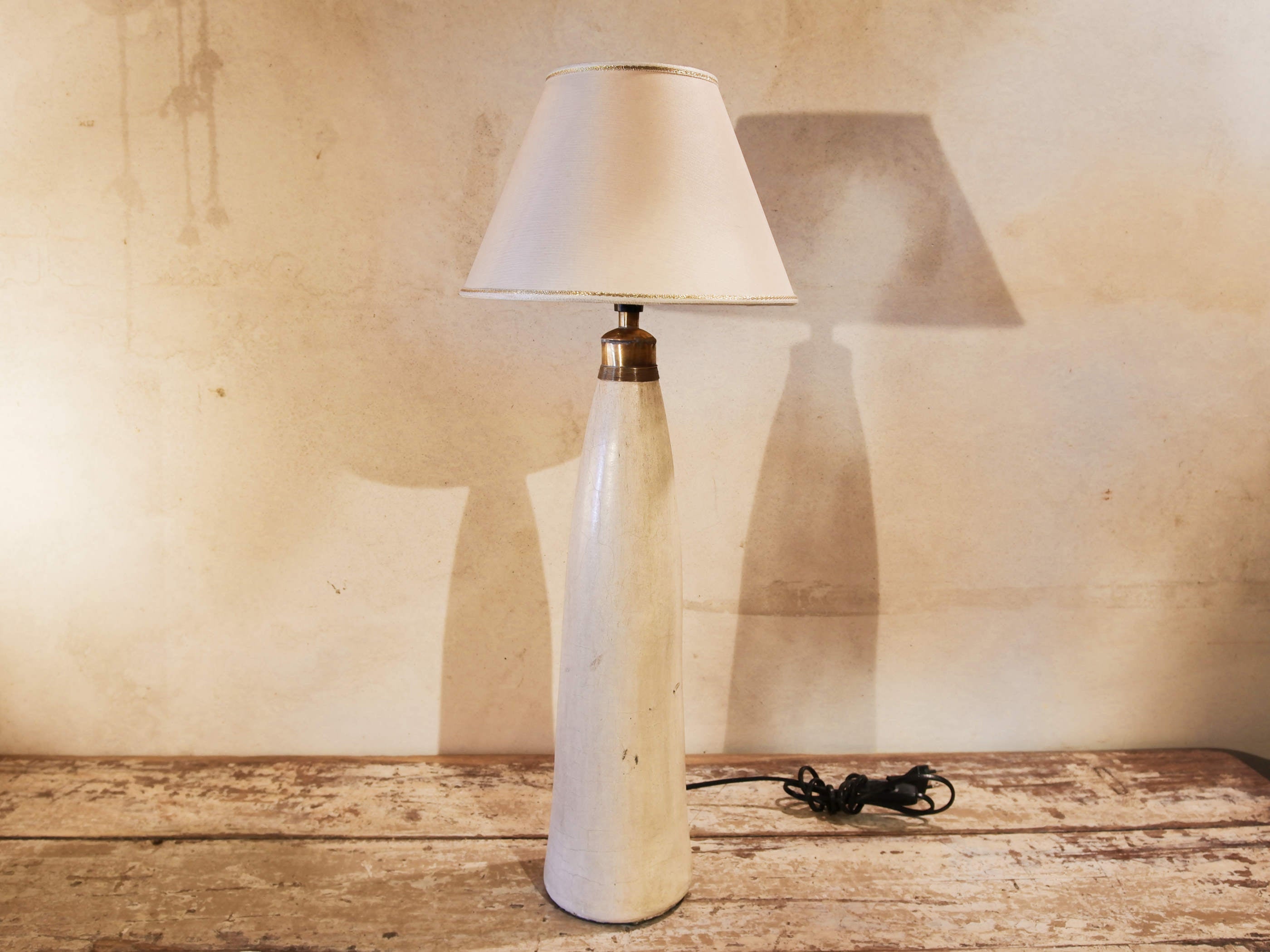 Lampada creata con vaso tadelakt, un intonaco di origine marocchina tipico della città di Marrakech, un metodo completamente ecologico basato sull'utilizzo di calce idrata, sapone nero, pigmenti naturali e cere. Dimensioni vaso compreso impianto diametro 11 h 52 cm, ingombro totale compreso paralume diametro 25 h 65cm.