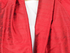 Scialle indiano in shantung di seta , un tessuto di seta selvaggia, di colore unito, caratterizzato da una superficie ruvida, molto irregolare e dall'aspetto grezzo di colore rosso.