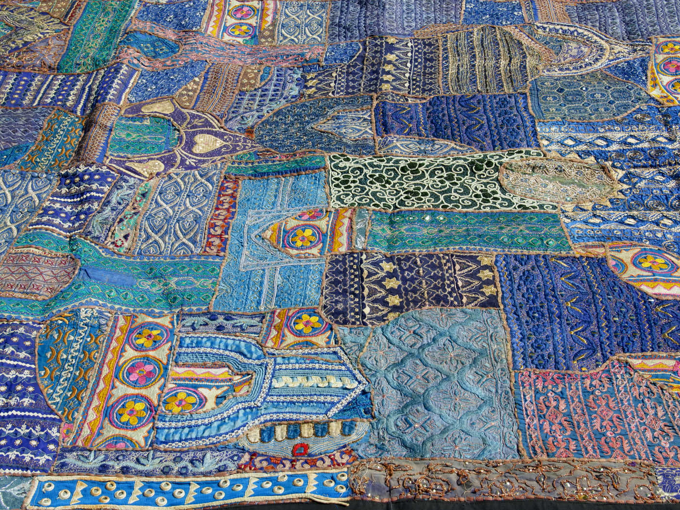 vecchio arazzo in cotone, lavorato artigianalmente a mano con tecnica patchwork.  per ogni pezzo ci possono volere mesi di lavoro sia per i ricami che per la ricerca di elementi, pezzi di tessuto antico, da abbinare all'arazzo.  tipici dell'india del nord, in Rajasthan  l'arazzo in casa è simbolo di fortuna e prosperità.  Pezzo Unico. Ideale come tessuto da appendere a parete ma si puo' impiegare anche come tappeto.    Dimensioni 160x240cm