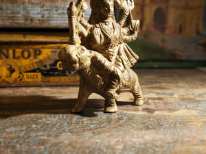 statuetta di Durga indiana in metallo inciso artigianalmente .  Presso la religione induista  "colei che difficilmente si può avvicinare" è una forma di Devi , ovvero della Madre Divina (che assume anche molte altre forme, tra cui Sarasvati , Parvati, Lakshmi, Kālī).