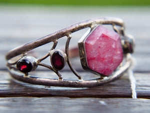 bracciale indiano fatto a mano, base in argento 925 con pietre, radice di rubino e granati  pezzo unico raro e di difficile lavorazione , parti a sbalzo , incastonatura , pietre tagliate .... il bracciale è lasciato con la patina originale , su richiesta si può portare lucido o rodiato .   altezza massima 3 cm spessore massmo 1,5 cm circonferenza ( comunque regolabile ) 21 cm peso 33 gr 