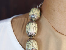 Carica l&#39;immagine nel visualizzatore di Gallery, collana nepalese / tibetana con bull in resina montate su argento lavorato, inciso a mano. assemblata artigianalmente, pezzo unico . collana con chiusura ad &quot;S&quot; , intervallata con elementi in argento .  lunghezza totale collana 56 cm misura sfera centrale 3.5 x 2 cm peso 150 gr