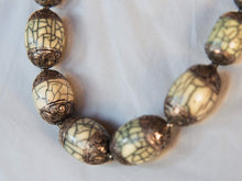 Carica l&#39;immagine nel visualizzatore di Gallery, collana nepalese / tibetana con bull in resina montate su argento lavorato, inciso a mano. assemblata artigianalmente, pezzo unico . collana con chiusura ad &quot;S&quot; , intervallata con elementi in argento .  lunghezza totale collana 56 cm misura sfera centrale 3.5 x 2 cm peso 150 gr