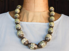 Carica l&#39;immagine nel visualizzatore di Gallery, collana nepalese / tibetana con bull in resina montate su argento lavorato, inciso a mano. assemblata artigianalmente, pezzo unico . collana con chiusura ad &quot;S&quot; , intervallata con elementi in argento .  lunghezza totale collana 56 cm misura sfera centrale 3.5 x 2 cm peso 150 gr