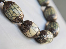 Carica l&#39;immagine nel visualizzatore di Gallery, collana nepalese / tibetana con bull in resina montate su argento lavorato, inciso a mano. assemblata artigianalmente, pezzo unico . collana con chiusura ad &quot;S&quot; , intervallata con elementi in argento .  lunghezza totale collana 56 cm misura sfera centrale 3.5 x 2 cm peso 150 gr