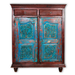 Credenza indiana in legno di teak riciclato con 2 cassetti e 2 ante. Mobile etnico assemblato con solo incastri in legno, senza cavicchi in metallo con l'utilizzo di legno vecchio recuperato e vecchie ante incise con motivi floreali, laccato in base di gesso azzurro su legno, lavorato ed assemblato artigianalmente. Pezzo unico. Dimensioni 120x45xh150cm.